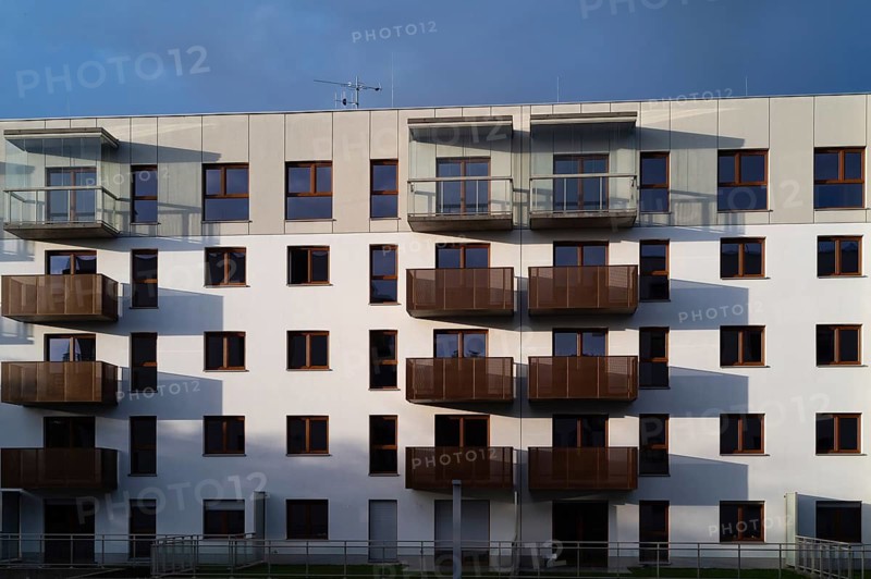 Facade of an apartment block with balconies in the afternoon sun