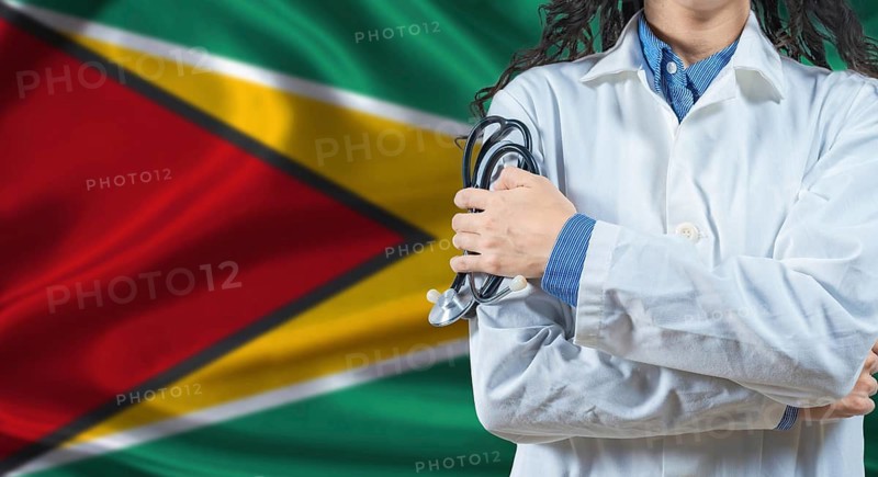 Healthcare professional with Guyana flag background. Professional doctor holding stethoscope on Guyana flag background