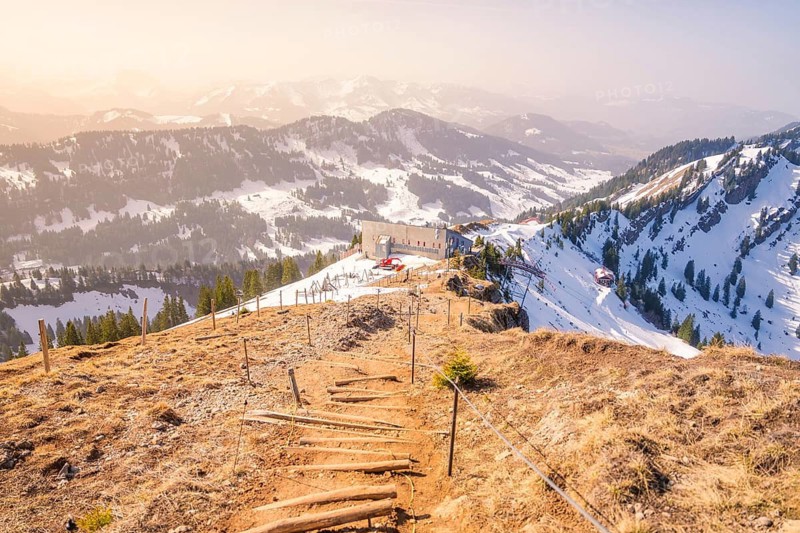 Panoramic view of snow-covered mountains and mountain hut, path in the foreground, Hochgrat Mountains, Allgäu Alps, Oberreute, Germany