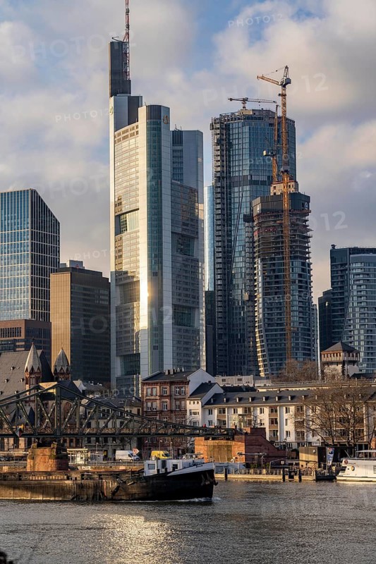 Skyline of the city centre of Frankfurt am Main, river Main, Eiserner Steg bridge, freighter, dusk, Hesse, Germany