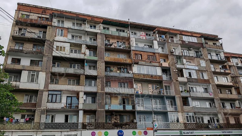Large apartment block with many floors and balconies under cloudy sky, Tbilisi, Georgia