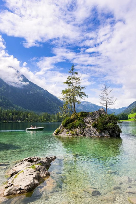 Hintersee near Ramsau with clear green water, surrounded by forests and mountains under a cloudy sky, pedal boat, Berchtesgaden National Park, Berchtesgadener Land, Upper Bavaria, Bavaria, Germany