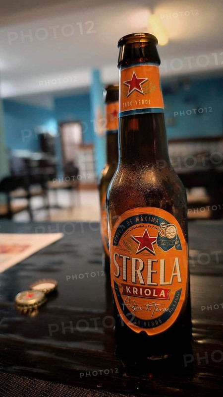 Close-up of a Strela Kriola beer bottle on a table in a restaurant, Ponta do Sol, hiking, Santo Antao, Cabo Verde, Cape Verde
