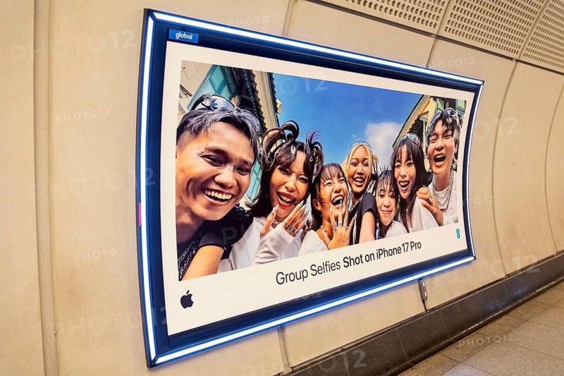 Advertising poster for Group Selfies Shot on iPhone 17 Pro, Transport for London (TfL) underground train station, London, England, UK