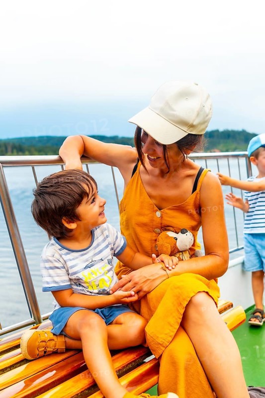 Mother and son tourists on a boat on Lake Titisee in the Black Forest, Germany