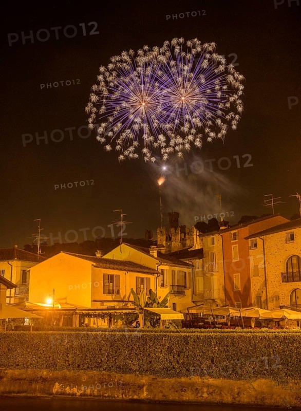 Fireworks from the Scaliger castle in the foreground Houses of, Borghetto, Valeggio sul Mincio, Province of Verona, Italy