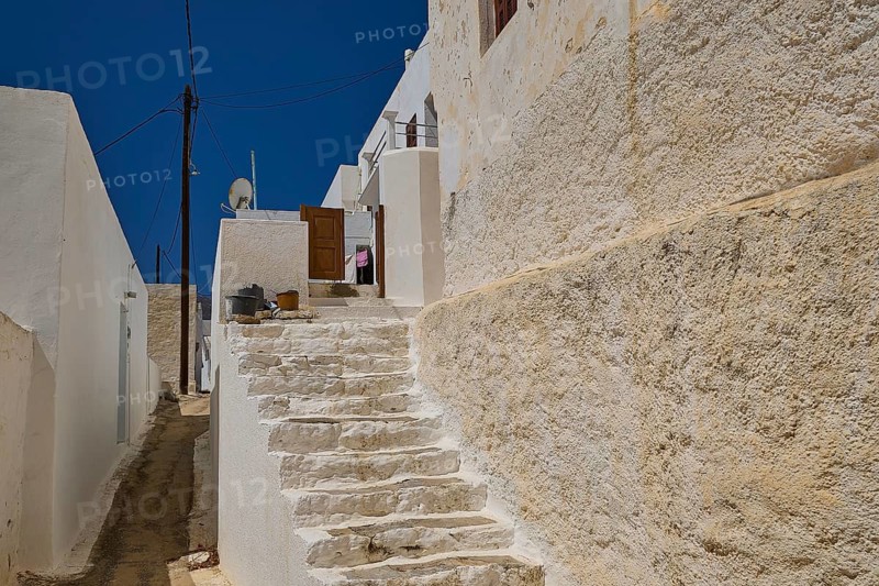 Stone staircase between white houses under clear blue sky, Megalo Chorio, Zero Waste Island, Tilos, Dodecanese, Greek Islands, Greece