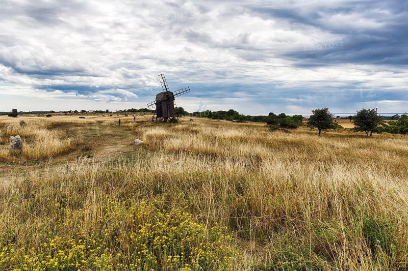 Picturesque landmark, dry grassland, Alvar, historic trestle windmill, Stora Alvaret, UNESCO World Heritage Site, agricultural landscape of South Öland, dramatic cloudy sky, Gettlinge, Südoeland, Öland island, Kalmar län, Sweden
