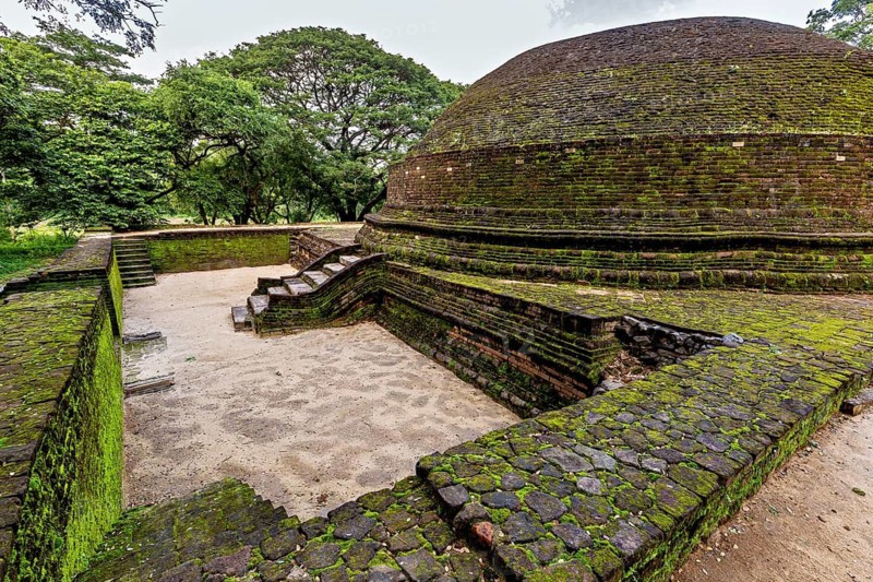 Ancient stupa covered with moss, showing traces of the past, temple ruins near Sigiriya in Sri Lanka