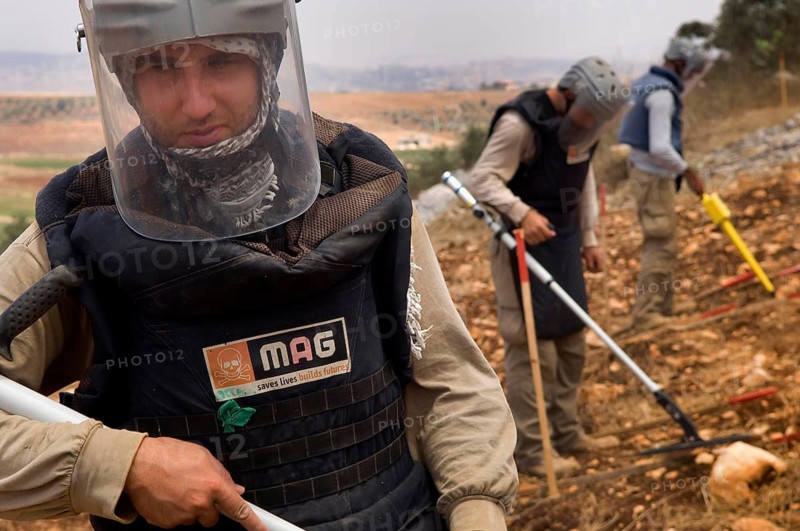 Tyre, Lebanon. July 15th 2010 A team from The Mines Advisory Group (MAG) clearing unexploded cluster munitions in the farmland of southern Lebanon