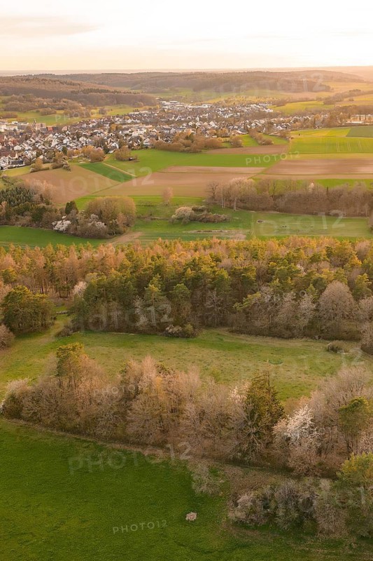 View over meadows and forests to a nearby town in the evening light, e-bike tour, old sports ground in Gechingen, Hecken and Gäu region, Calw district, Germany