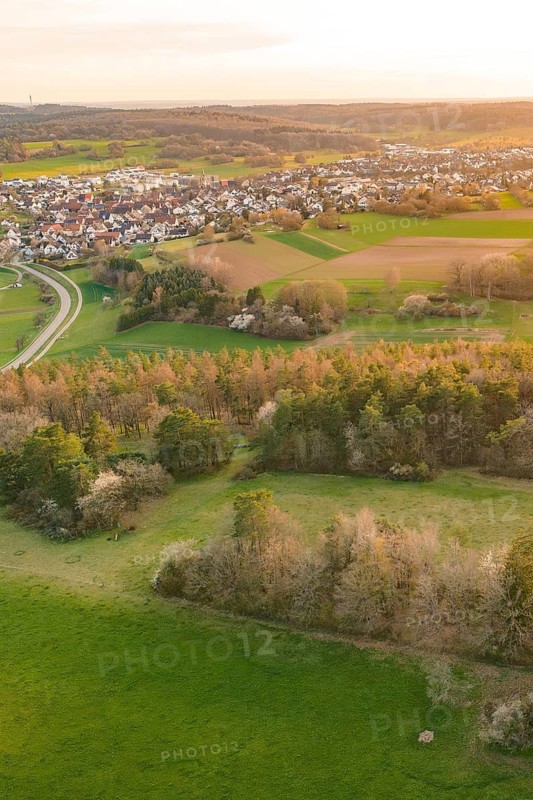 Village view with fields and meadows at sunset, nestled in a gentle hilly landscape, e-bike tour, old sports field in Gechingen, hecken and Gäu region, Calw district, Germany