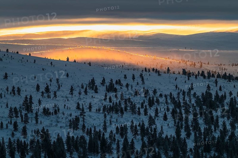 Lighting over snow-covered mountain ranges, Urho Kekkonen National Park, Lapland, Finland, January 2025