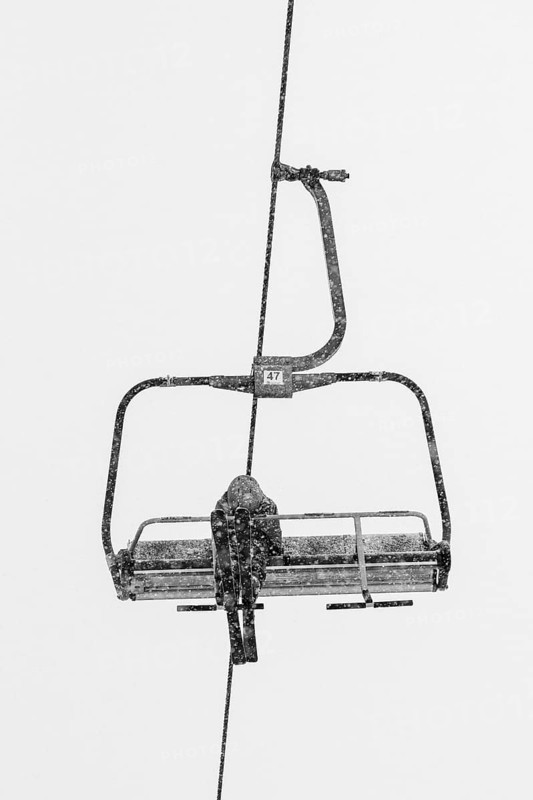 Skier on the ski lift sofa during cold day