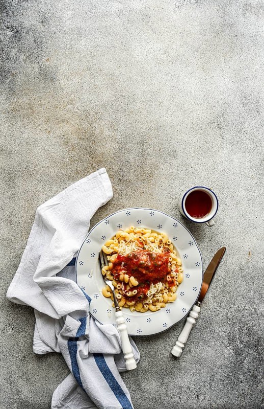 A plate of delicious chifferi rigati pasta topped with rich tomato sauce and cheese. Served on a beautiful ceramic plate, this dish is perfectly suited for a gourmet meal