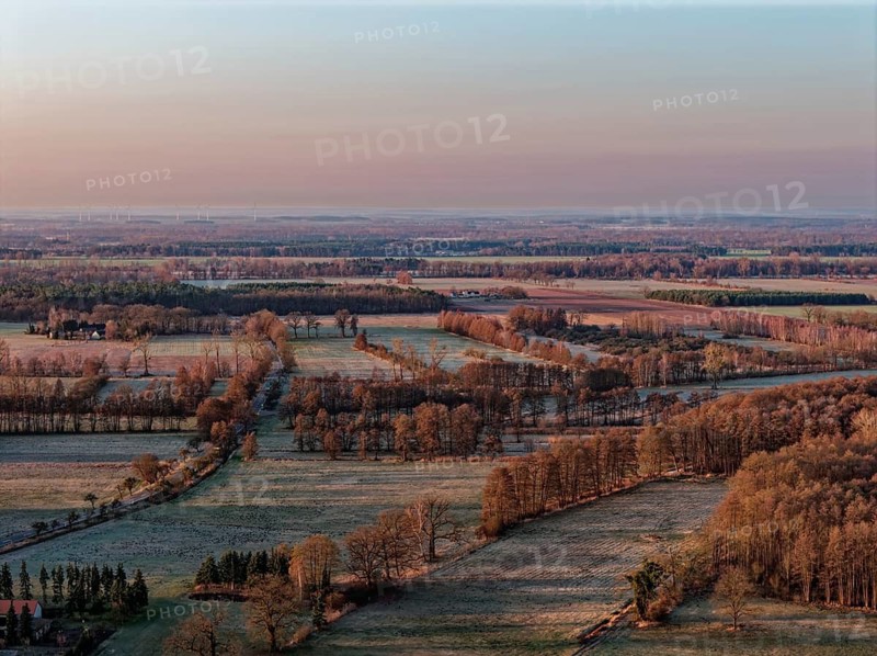 Reif lies in some fields in the countryside in the UNESCO Drömling Biosphere Reserve in the Altmark early in the morning on a cold spring day. aerial view. Dannenfeld, Gardelegen, Saxony-Anhalt, Germany