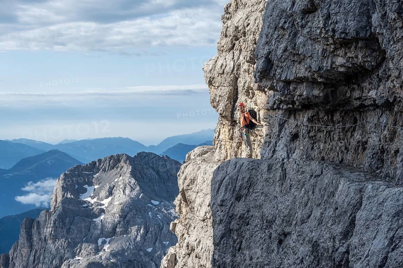 Climbers on a rock band, Bocchette Centrale band trail, via ferrata in the Brenta Mountains, Brenta-Adamello Natural Park, Trentino, Italy