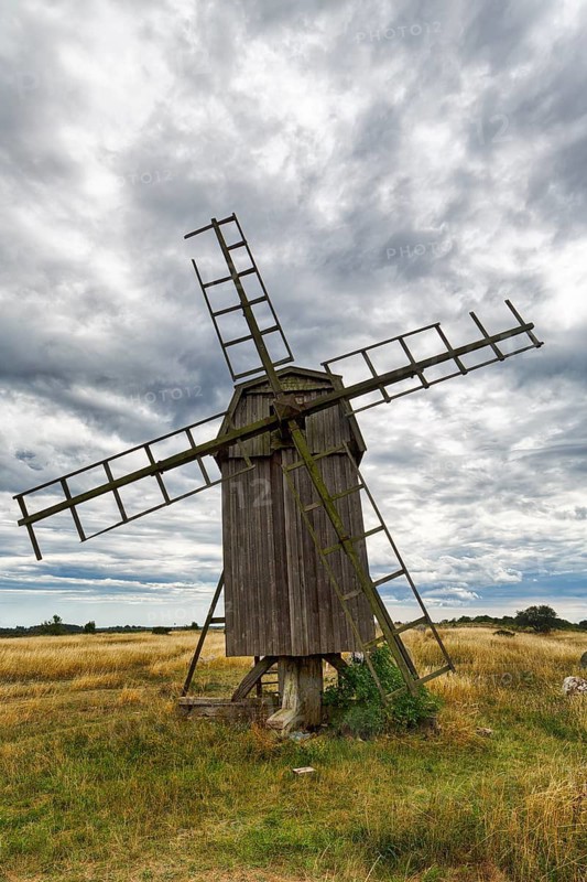 Historic windmill, Stora Alvaret, UNESCO World Heritage Site, South Öland agricultural landscape, dramatic cloudy sky, Gettlinge, Südoeland, Öland island, Kalmar län, Sweden