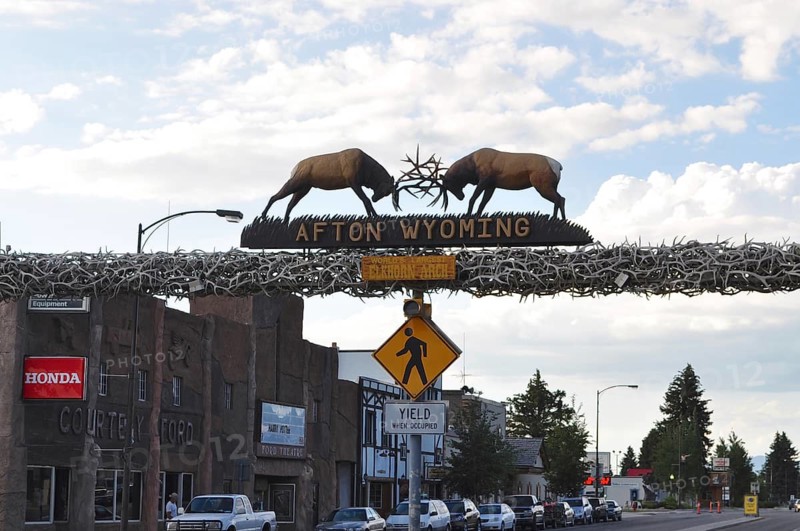 An arch with a deer sculpture straddles a road in Afton, Wyoming, Wyoming, USA