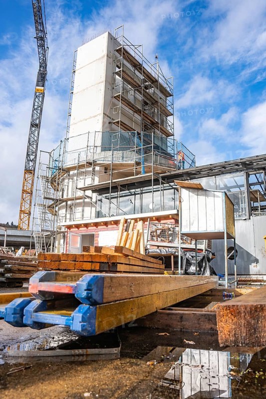 Wooden beams and reflecting puddle on a lively construction site, extension of the Calw railway station for the new track of the Hermann Hessebahn, Calw, Black Forest, Germany