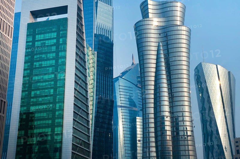 Modern glass fronted high rise skyscrapers and office towers of the financial district line the Doha skyline, Qatar, Middle East