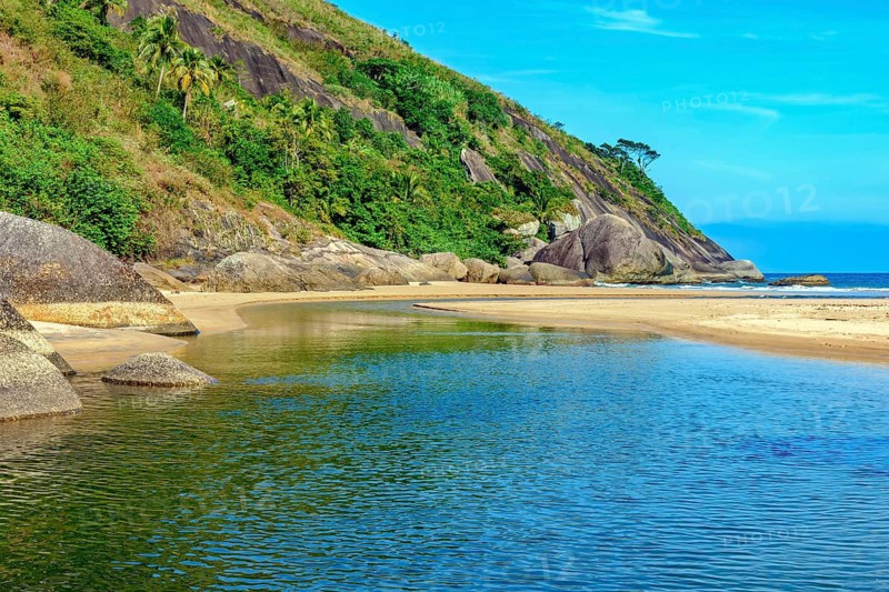River flowing into the sea at Bonete beach in Ilhabela on the north coast of Sao Paulo, Ilhabela, Sao Paulo, Brazil