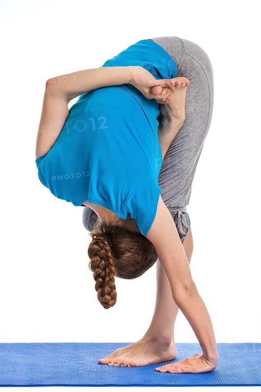 Yoga, young beautiful woman yoga instructor doing Half Bound Lotus Standing Forward Bend (Ardha Baddha Padmottanasana) asana exercise isolated on white background