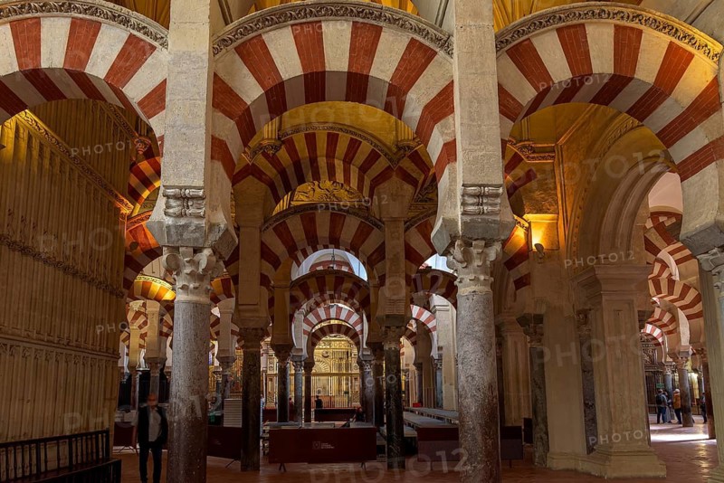 Columns and arches with red stripes in the cathedral mosque of Córdoba (Mezquita-Catedral), Cordoba, Andalusia, Spain