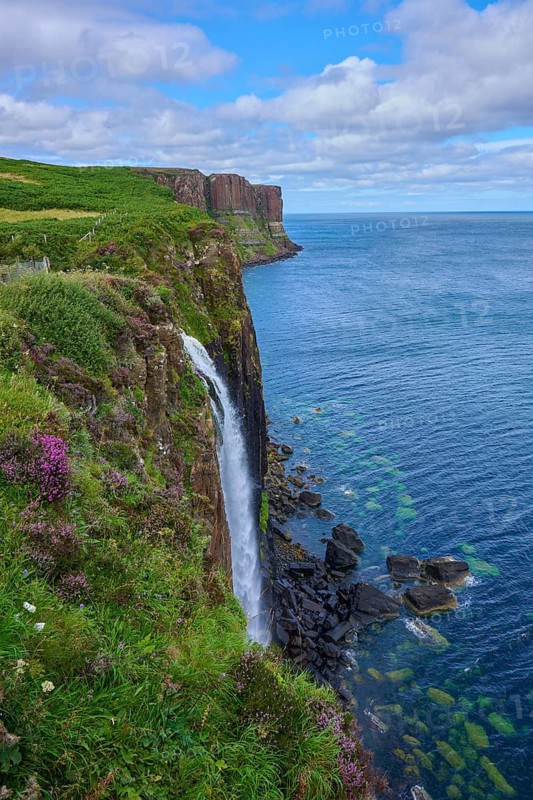 Breathtaking view of cliffs and seaside waterfall under a cloudy sky, Kilt Rock Waterfall, Portree, Isle of Skye, Scotland, United Kingdom, United Kingdom