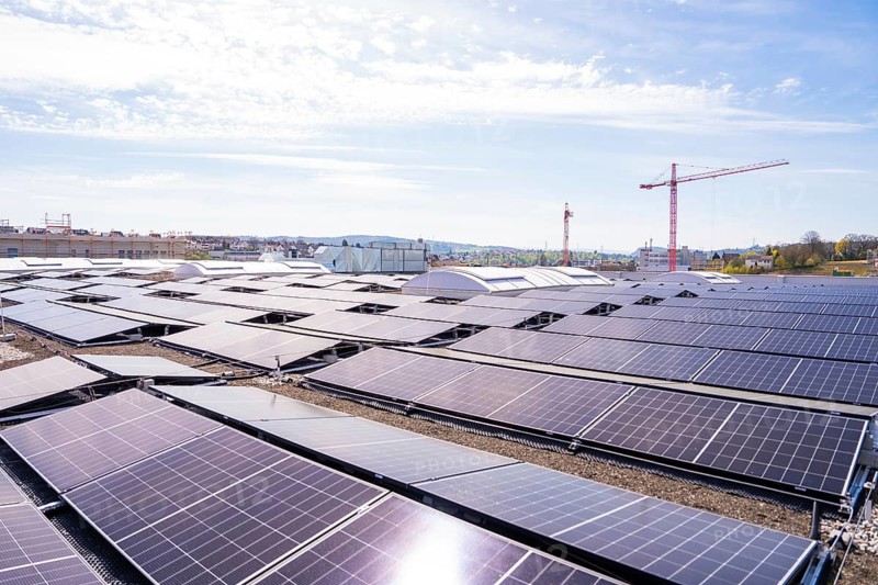 Solar systems with a crane in the background, integration of sustainable energy and urban development, PV installation. OBI Baumarkt, Mühlacker, Enzkreis, Germany