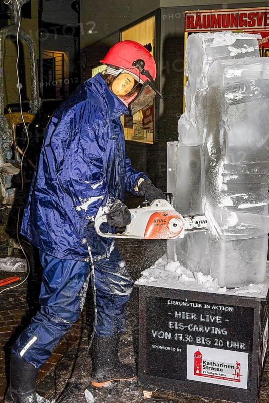 An ice sculpture is being created: ice carving street action as part of the long shopping night in the city center of Reutlingen, Baden-Württemberg, Germany, for editorial use only