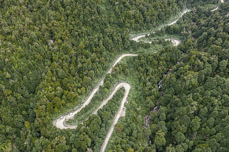 Aerial view of a winding road (Carretera Austral) through dense forest, south of Puyuhuapi, Aysén Region, Chile