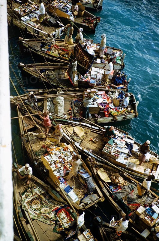 Small open boats in which merchants sell souvenirs and products to the passengers of a ship, Aden, Yemen 1956