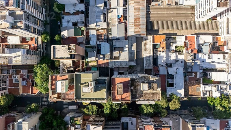 Top view, of the dense layout of Rosario, Argentina. The intricate array of buildings, streets, and rooftops are showcased in detail thanks to the high perspective shot by a drone