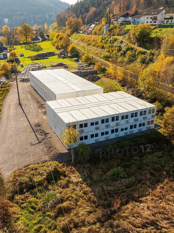 Commercial building in a small mountain village surrounded by autumnal trees, refugee accommodation Beermiß, Calmbach, Black Forest, Germany
