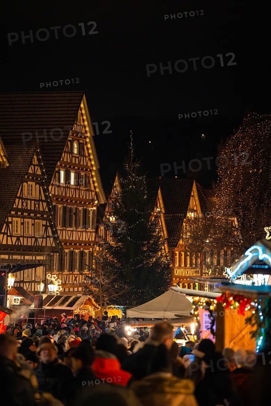 Crowd at a Christmas market in front of illuminated half-timbered houses at night, Christmas market Calw, Black Forest, Germany
