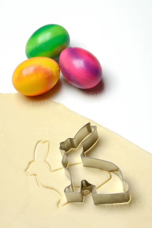 Rolled dough with bunny cookie cutter and easter eggs