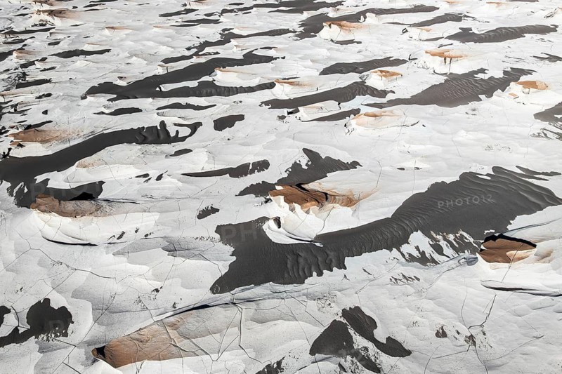 This aerial view captures the unique pumice field in Catamarca, Argentina. The striking contrast of textures and colors showcases the raw beauty of volcanic activity