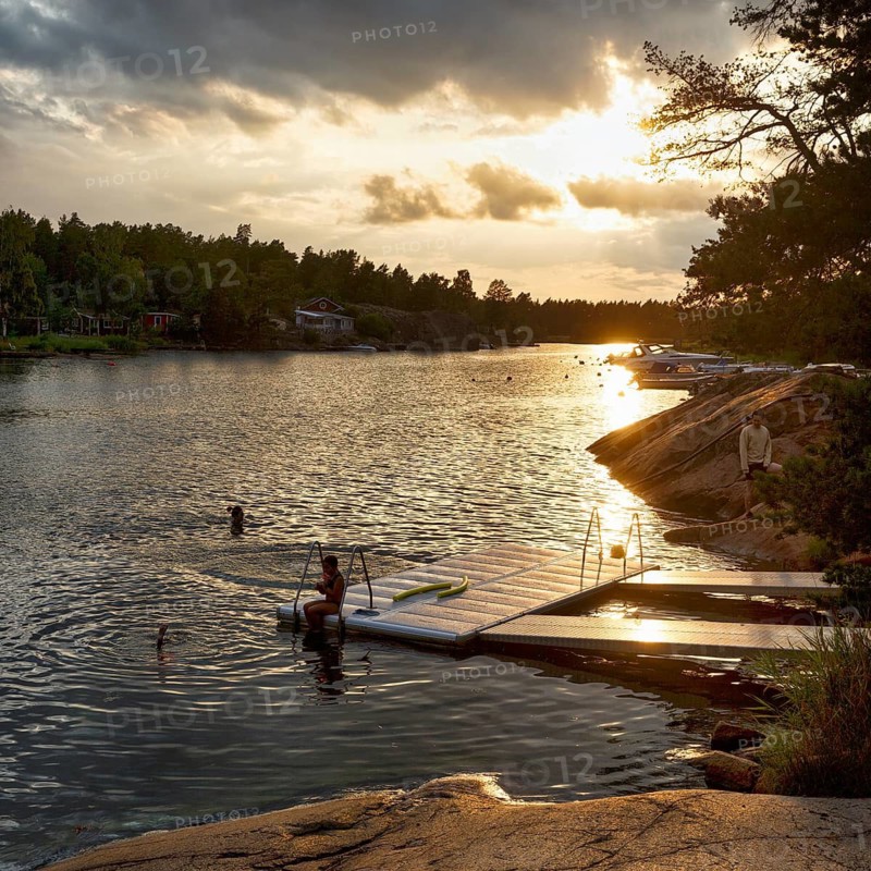 Picturesque swimming area, visitors at the jetty, idyllic Scandinavian landscape, Sound, sunset, Åsvallesund, Oskarshamn, Kalmar län, Smaland, Sweden