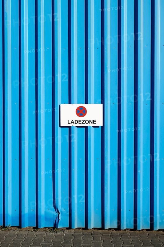 Loading zone sign on a blue wall of a commercial building in the eastern harbour, Frankfurt am Main, Hesse, Germany