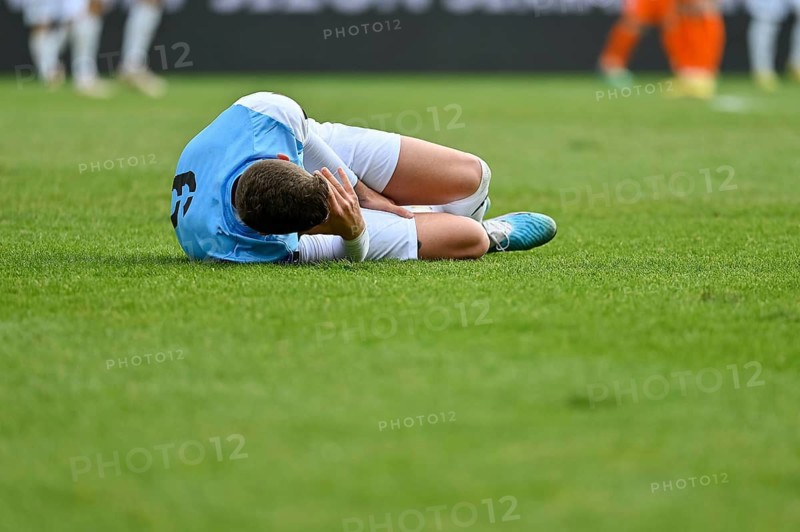 The injured footballer lies on the pitch in Lubin, Poland