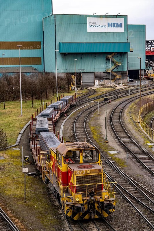 Hüttenwerke Krupp-Mannesmann, HKM in Duisburg, goods train with new steel slabs leaving the halls of the steel mill, tracks of the marshalling yard, North Rhine-Westphalia, Germany