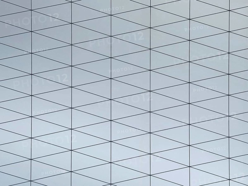 A gray surface featuring a modern geometric pattern composed of interconnected triangles. The design seamlessly blends simplicity with a sophisticated, contemporary style