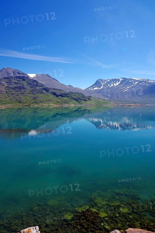 Clear lake with reflection of snow-capped mountains, peaceful atmosphere, Igaliku, North America, Greenland, Denmark