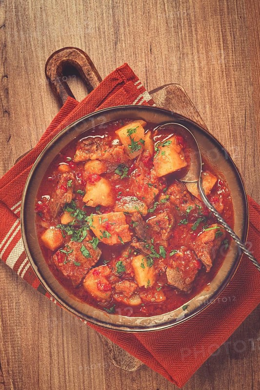 Potatoes with meat, stewed in tomato sauce, with spices and herbs, homemade, no people