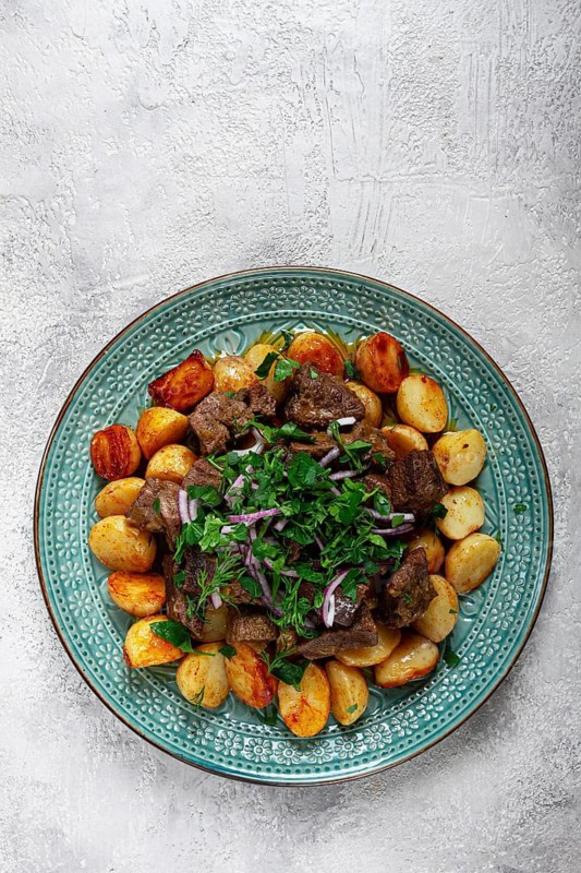 Kuyrdak, roast offal with potatoes and fresh herbs, homemade in Kazakh, no people