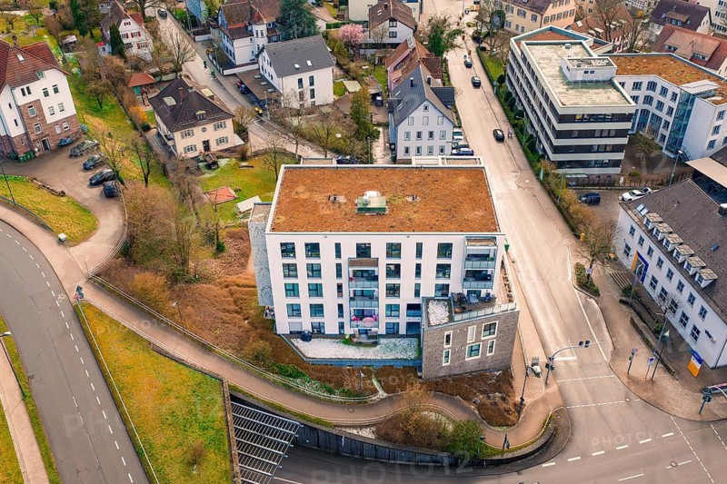 Residential complex at a crossroads with surrounding houses and small green spaces, Nagold, Calw district, Germany