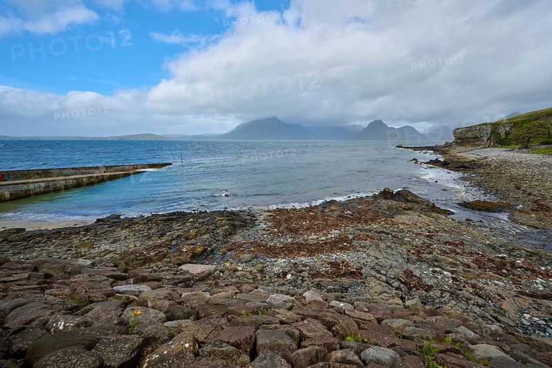 Rocky coast with sea views and mountains in the background under cloudy sky, Elgol Beach, Elgol, Isle of Skye, Scotland, United Kingdom, Great Britain