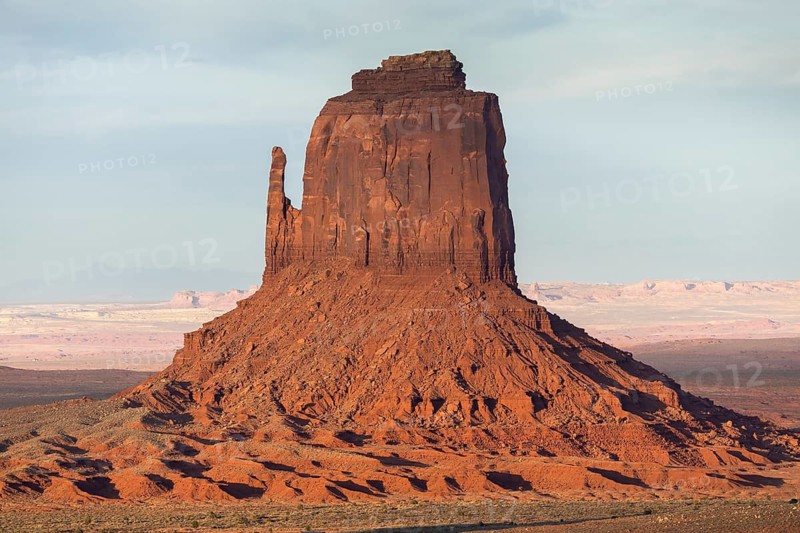 Captivating rock formation in Monument Valley, featuring striking red sandstone buttes under a clear sky. This iconic southwestern USA landscape epitomizes natural beauty