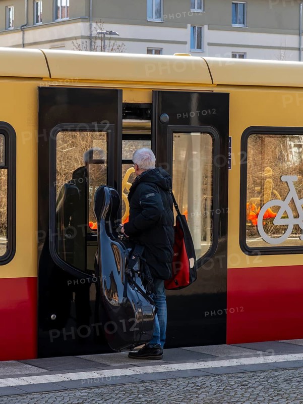 S-Bahn platform with passengers and the historic structures at Lichterfelde West station, Berlin, Germany